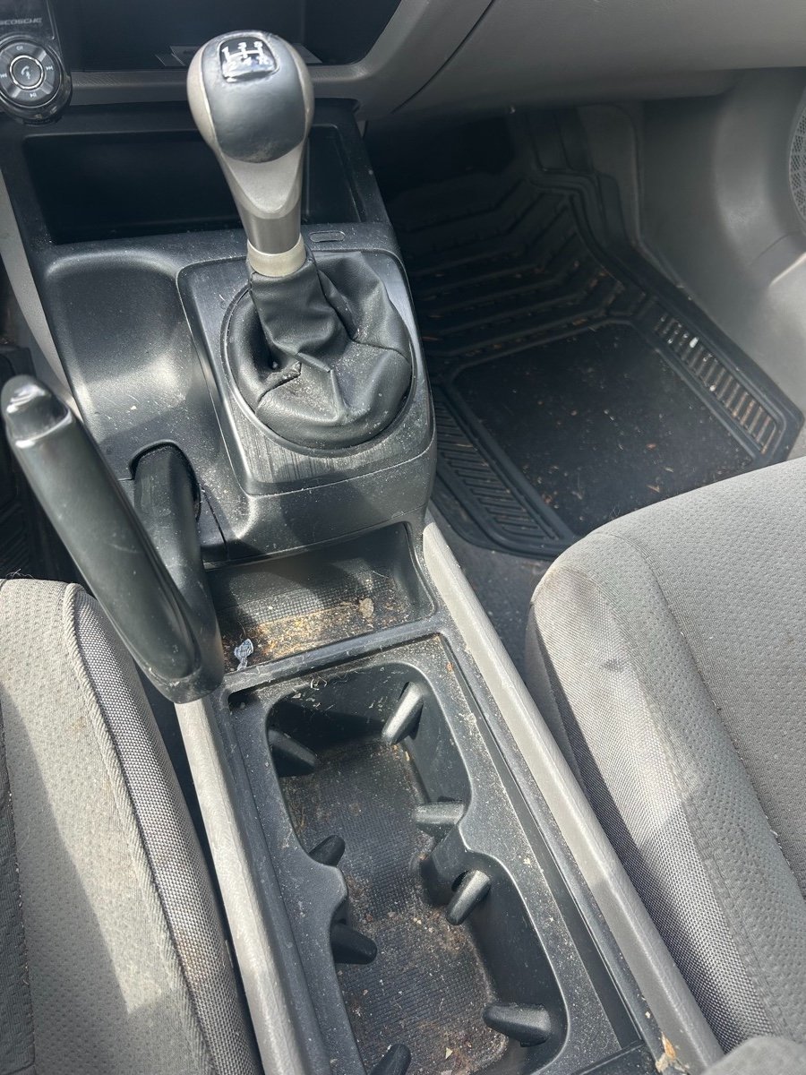Dirty car center console before detailing